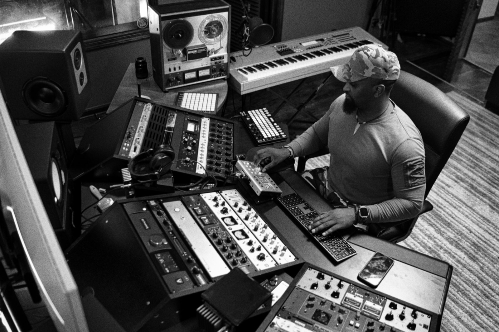 Giggz at the keyboard in the control room, black and white