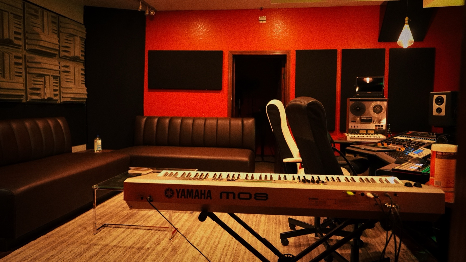 Xtrim Studios control room with lounge seating, Yamaha MO8 and tape machine